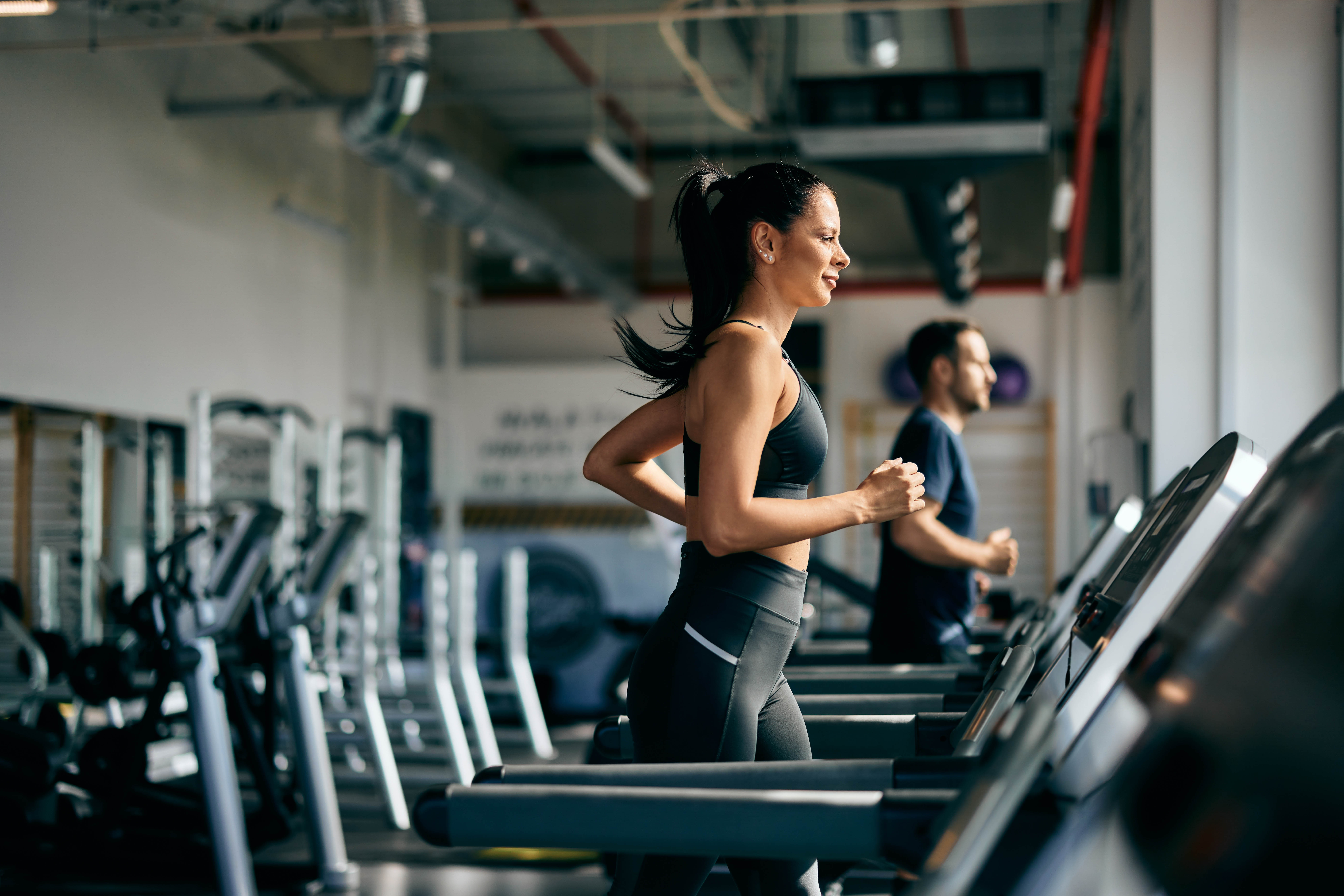 Woman running on the treadmill in the gym